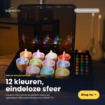 DORSETTO uppladdningsbara RGB LED-värmeljus (12 st) i svart ask med öppen lock - levereras med fjärrkontroll, lyser i flera färger, vattentäta (IP68), upp till 160 timmar. Text: "12 färger, oändlig stämning.