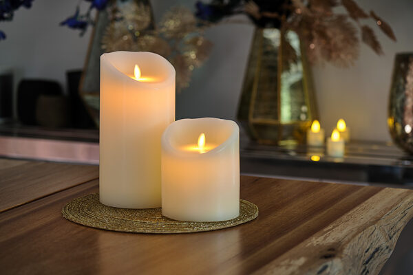 LED-vaxljus i två storlekar från DORSETTO på vävd gyllene bordstablett med varm och mysig belysning