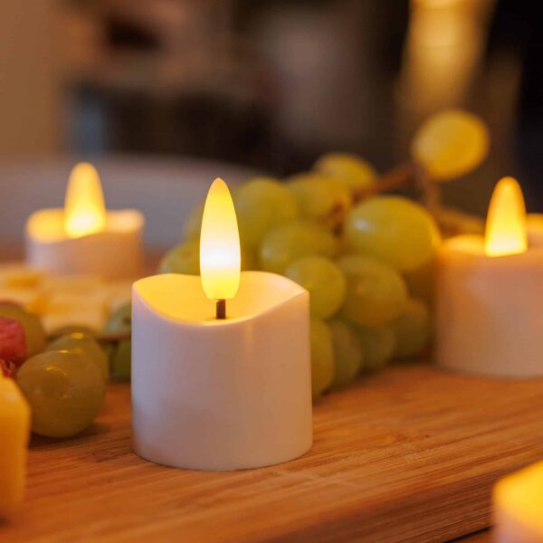 Set med 6 uppladdningsbara 3D LED-te-/värmeljus med timerfunktion, fjärrkontroll, svart laddbas, nätadapter och sex matta hållare för varm stämning.